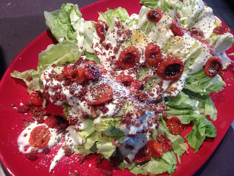 Wedge Salad with Roasted Tomatoes, bacon, and Chia Seeds.
