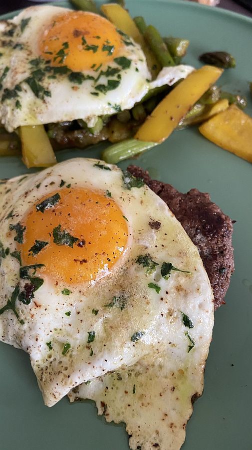Fried Eggs with Vegetables and Ground Beef - topped with parsley.