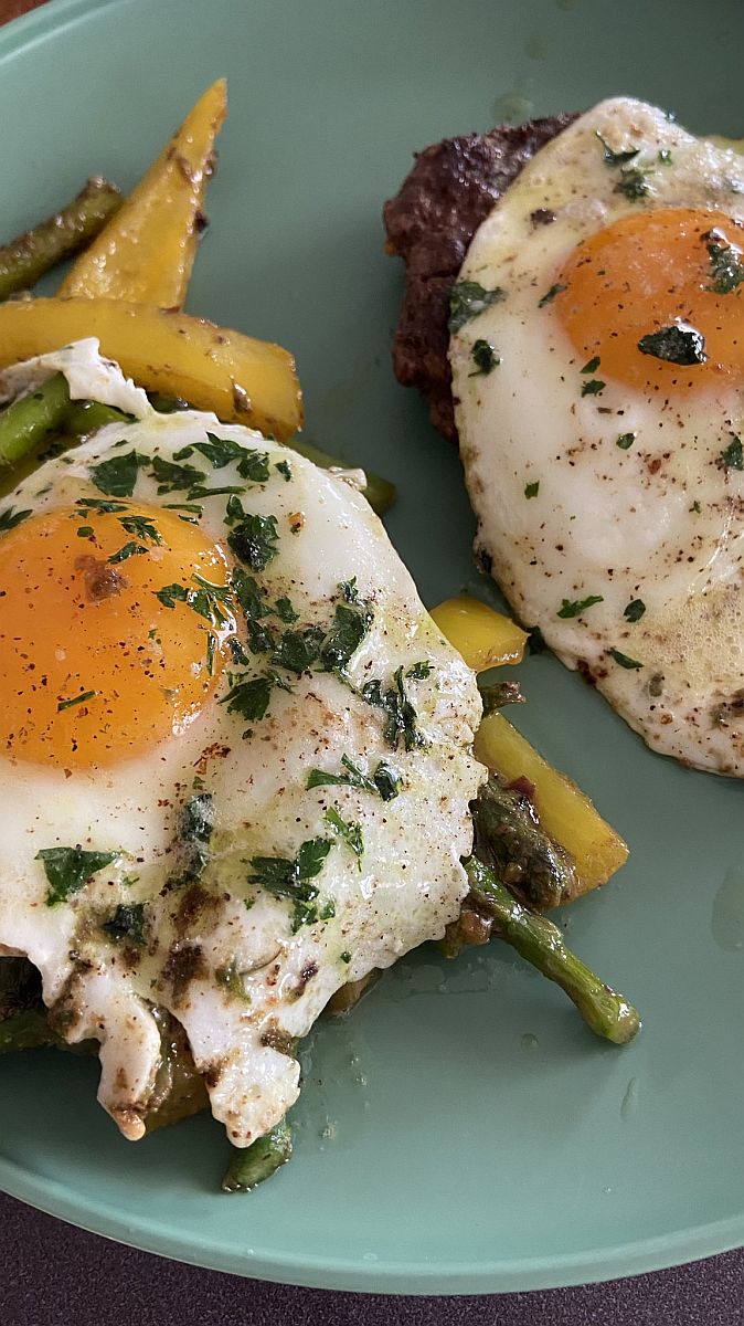 Fried Eggs with Vegetables and Ground Beef - topped with parsley.